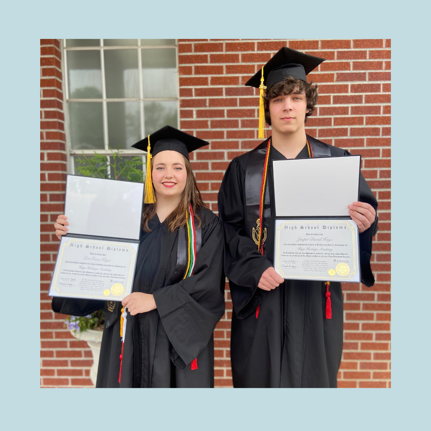 pic of boy and girl homeschool graduates with diplomas